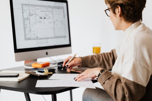 Image of woman looking at floor plans on a computer screen